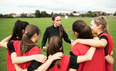 Rugby,Players,And,Their,Coach,Gathering,Before,A,Match